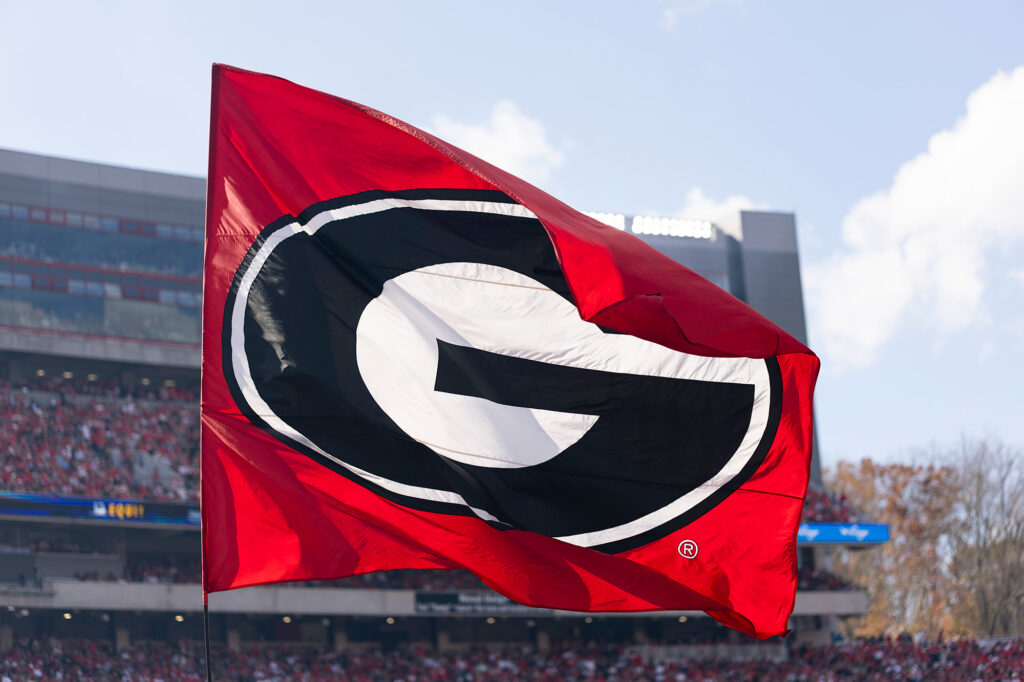 Detail of the Georgia flag as cheerleaders fly them in the end zones after a touchdown at the UNC Charlotte Football Game.