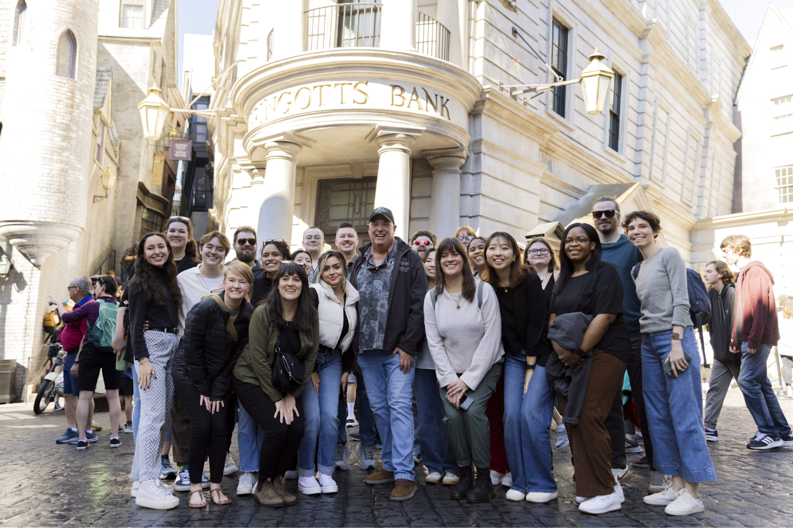NMI Students and staff pose with UGA alumnus Eric Baker (center) in front of the Gringotts Bank at the Universal Hollywood Studios park. (Elisa Fontanillas/UGA)