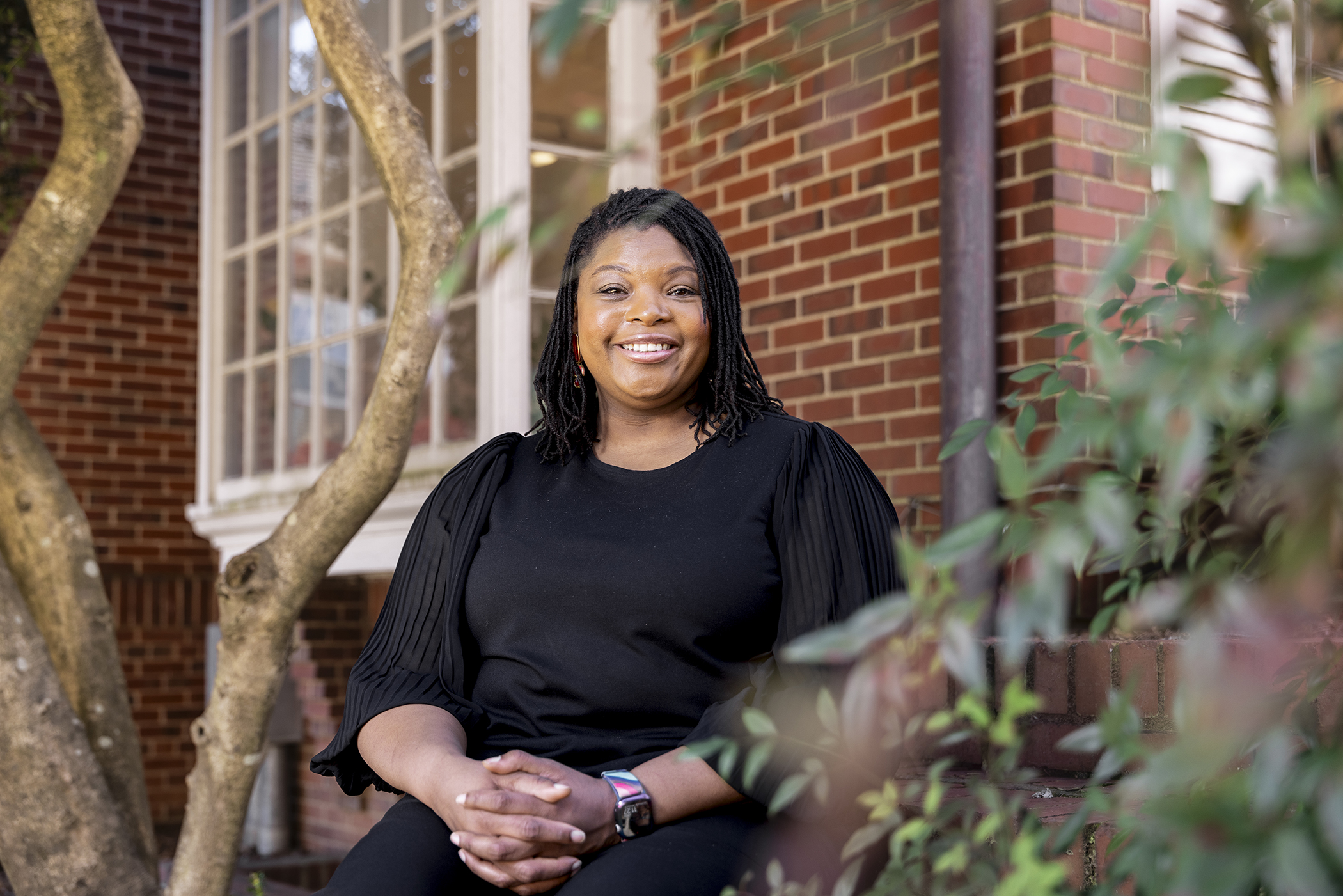 Portrait of Kimberly Watkins, Assistant Professor of Financial Planning, Housing and Consumer Economics in the College of Family and Consumer Sciences, outside the Charles Schwab Financial Planning Center.