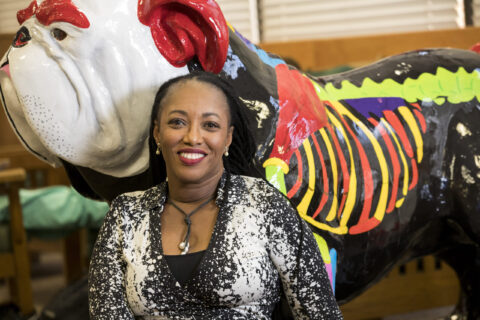 Paige Carmichael, with the AnAtomic Dawg statue in the Veterinary Medicine building