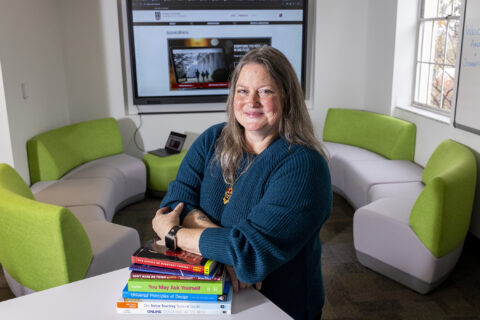 Environmental portrait of Amy Ragland, an instructional designer in the Office of Online Learning, in a common space of her office’s headquarters in Brooks Hall.