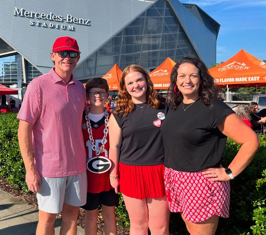 The Herrington family stands in front of Mercedes Benz stadium, dressed in UGA gear