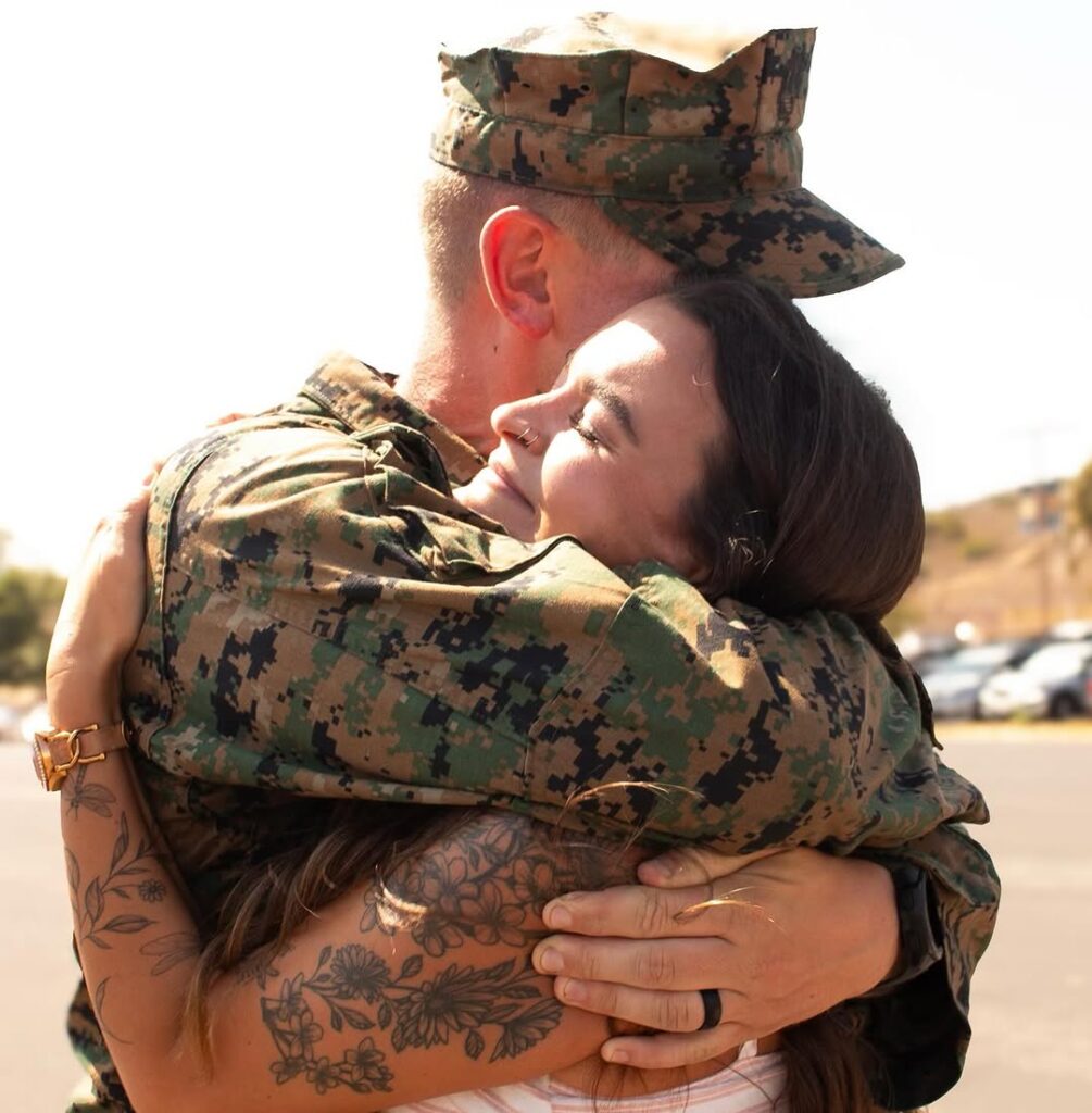 Student Courtney Adams hugs her husband, who is stationed in Southern California at Camp Pendleton