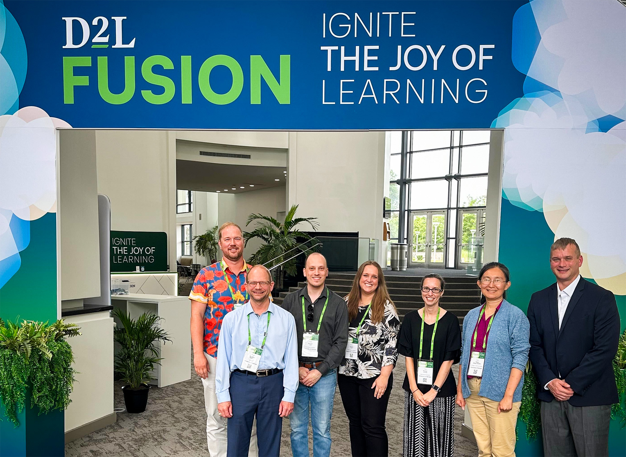 UGA Online team members stand in front of D2L Fusion conference sign.