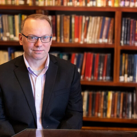 Timothy R Cain headshot in library