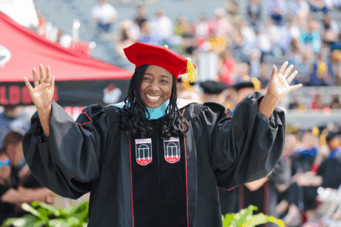 UGA doctoral graduate waves at commencement
